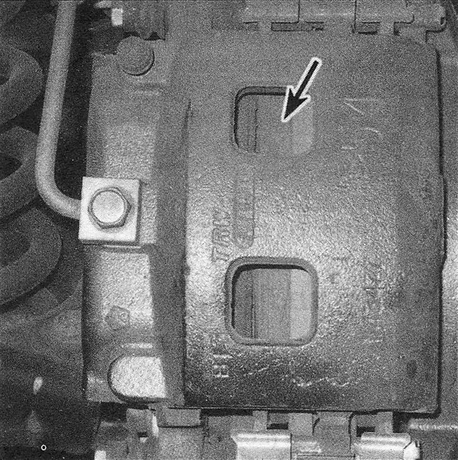 RAM Trucks With the wheel off, check the thickness of the inner pad through the inspection hole (front disc shown, rear disc caliper similar)