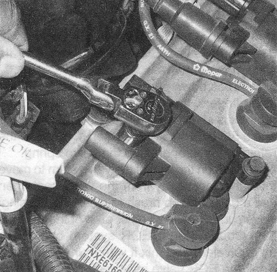 RAM Trucks On models with individual ignition coils, remove the mounting bolts and the individual coil (s) to access the spark plug(s) (one type shown, others similar)