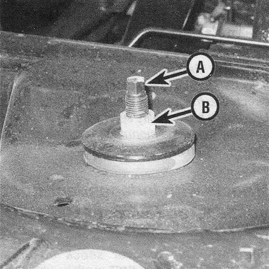 RAM Trucks Hold the shock absorber stem (A) with a wrench to prevent it from turning while loosening the upper ounting nut (B)