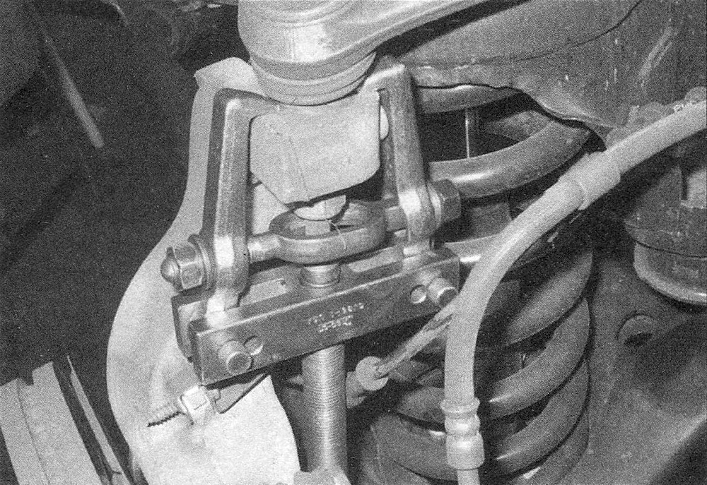 RAM Trucks Back off the nut a few turns, then separate the balljoint from the steering knuckle (leaving the nut on the ballstud will prevent the balljoint from separating violently)