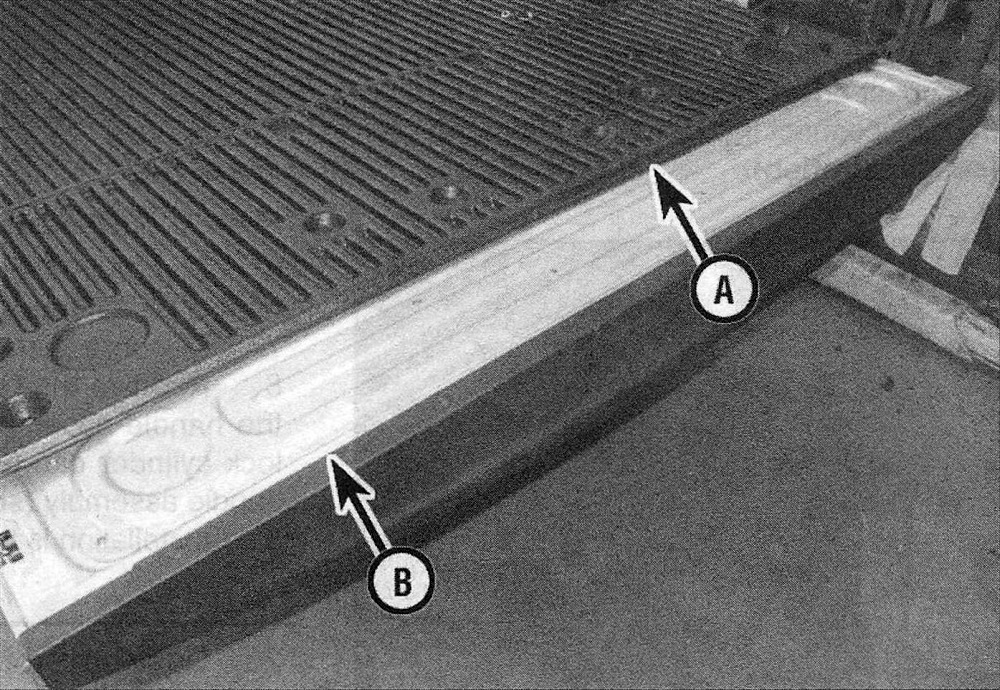 Ram Trucks Tailgate latch and handle - Remove the plastic liner (A) to reach the tailgate access panel (B)