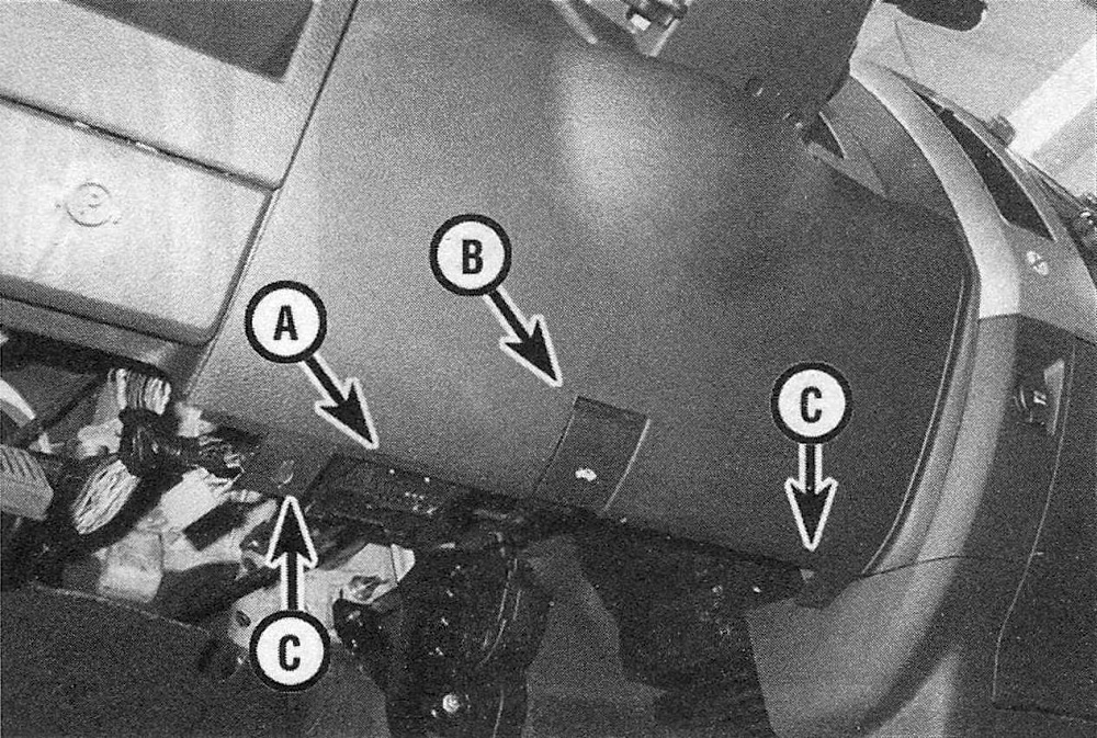 Ram Trucks Dashboard trim panels - Data link connector (A) and hood release handle (B); the lower cover can be pried off when the screws (C) are removed