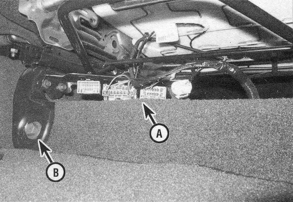 Ram Trucks Seats - Disconnect the wiring (A), then remove the seat mounting bolts (B)