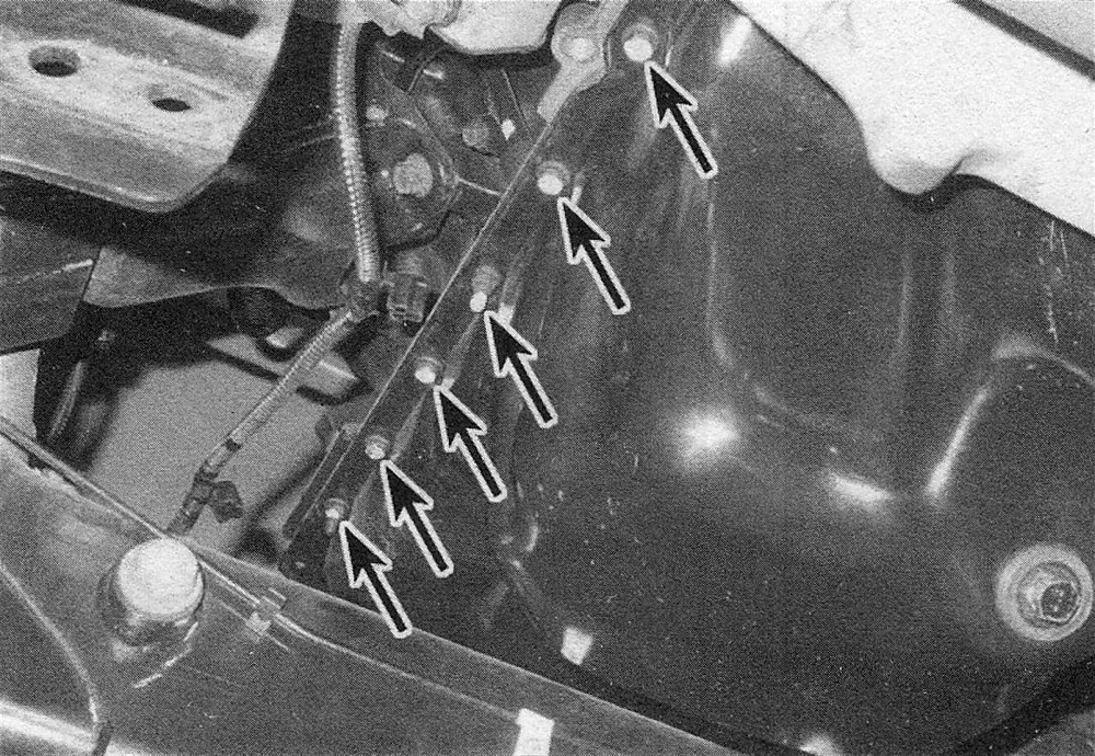 RAM Trucks Hemi engine Remove the oil pan mounting bolts from the perimeter of the oil pan - left side shown