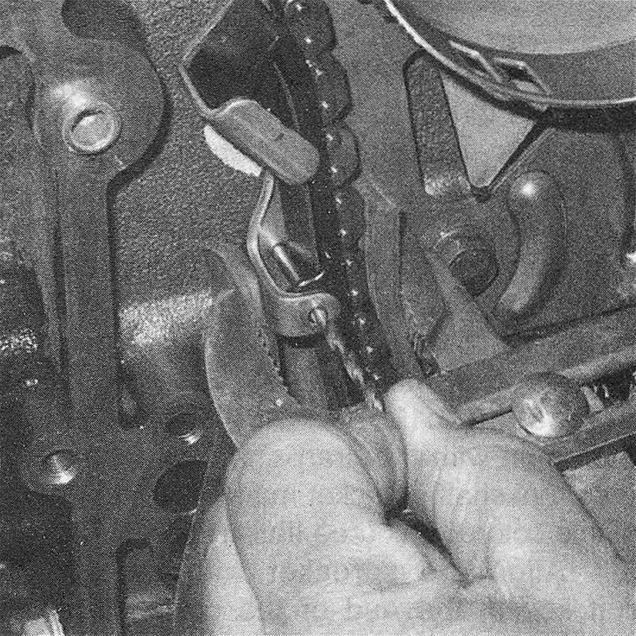 RAM Trucks Hemi engine Use a large pair of pliers to retract the tensioner until the hole in the tensioner aligns with the hole in the bracket (thrust plate), then install a drill bit through the hole to keep it in the retracted position