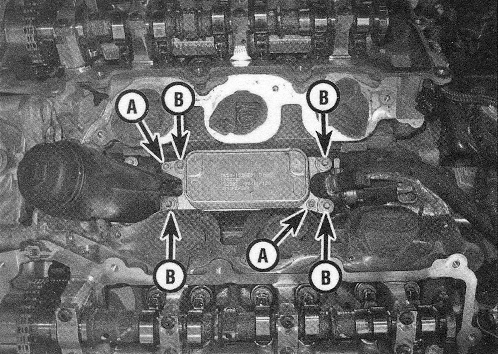 RAM Trucks 3.6L V6 engine  Remove the oil cooler mounting screws (A) and mounting bolts (B)