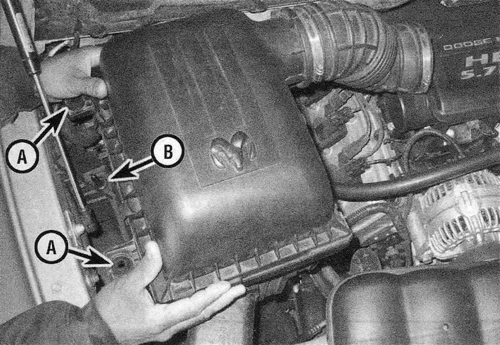 RAM Trucks Fuel and exhaust systems - gasoline engines To detach the air filter housing from the vehicle, grasp it firmly and lift it straight up to disengage the grommets (A) from their corresponding locator pins (B) (typical air filter housing shown)