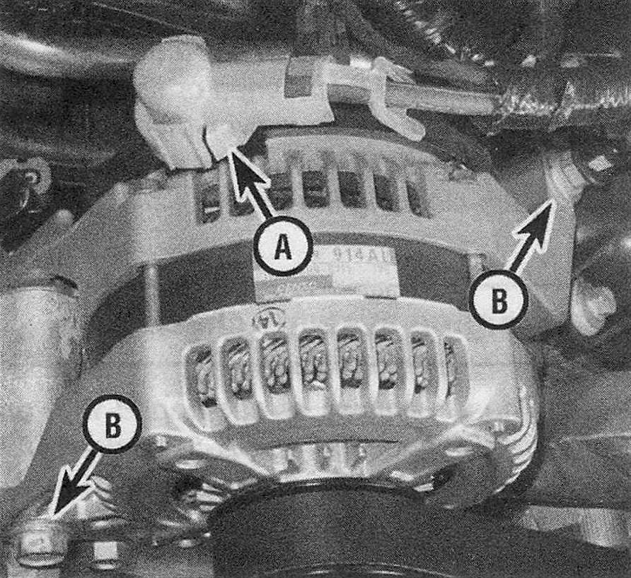 RAM Trucks Engine electrical systems Remove the nut from the battery output terminal stud (A) and disconnect the battery cable, then disconnect the electrical connector for the field terminal from the rear of the alternator - the mounting bolts are shown at (B) (4.7L V8 engine shown, 3.7L V6 engine similar)