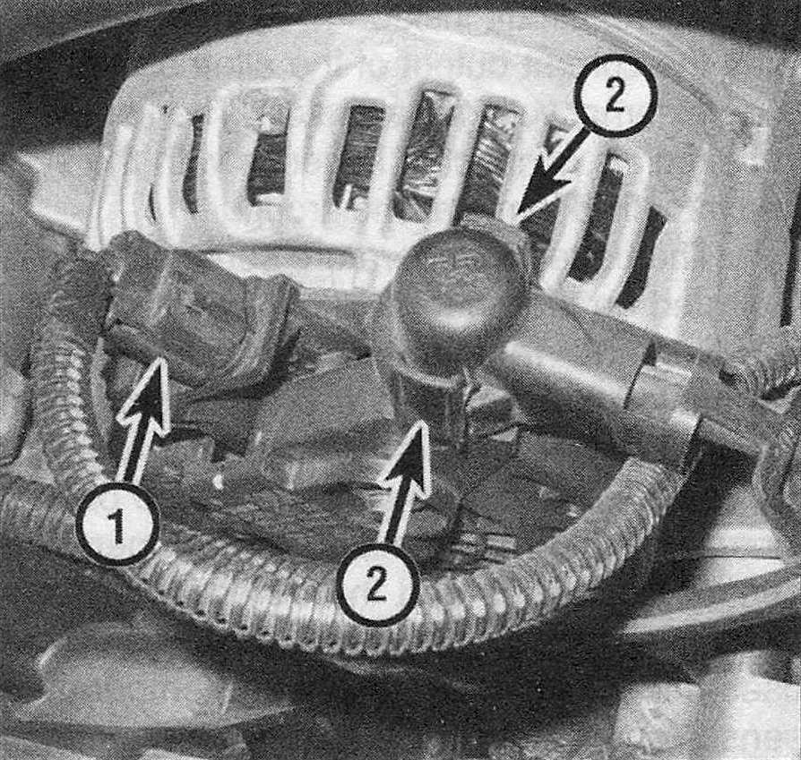 RAM Trucks Engine electrical systems Disconnect the field wire electrical connector (1) from the field terminal, then depress the two release tabs (2) on the plastic insulator cap, pull off the cap and remove the nut that secures the battery cable to the B+ terminal (Hemi engine)