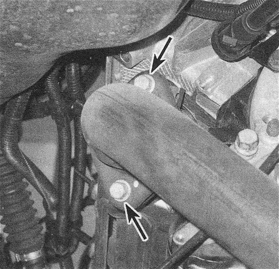 RAM Trucks To disconnect the exhaust pipe ahead of the catalyst from the exhaust manifold, remove these two bolts. If they're difficult to loosen, spray some penetrant onto the threads, wait awhile and try again. Discard these bolts and use new ones when reconnecting the pipe to the manifold