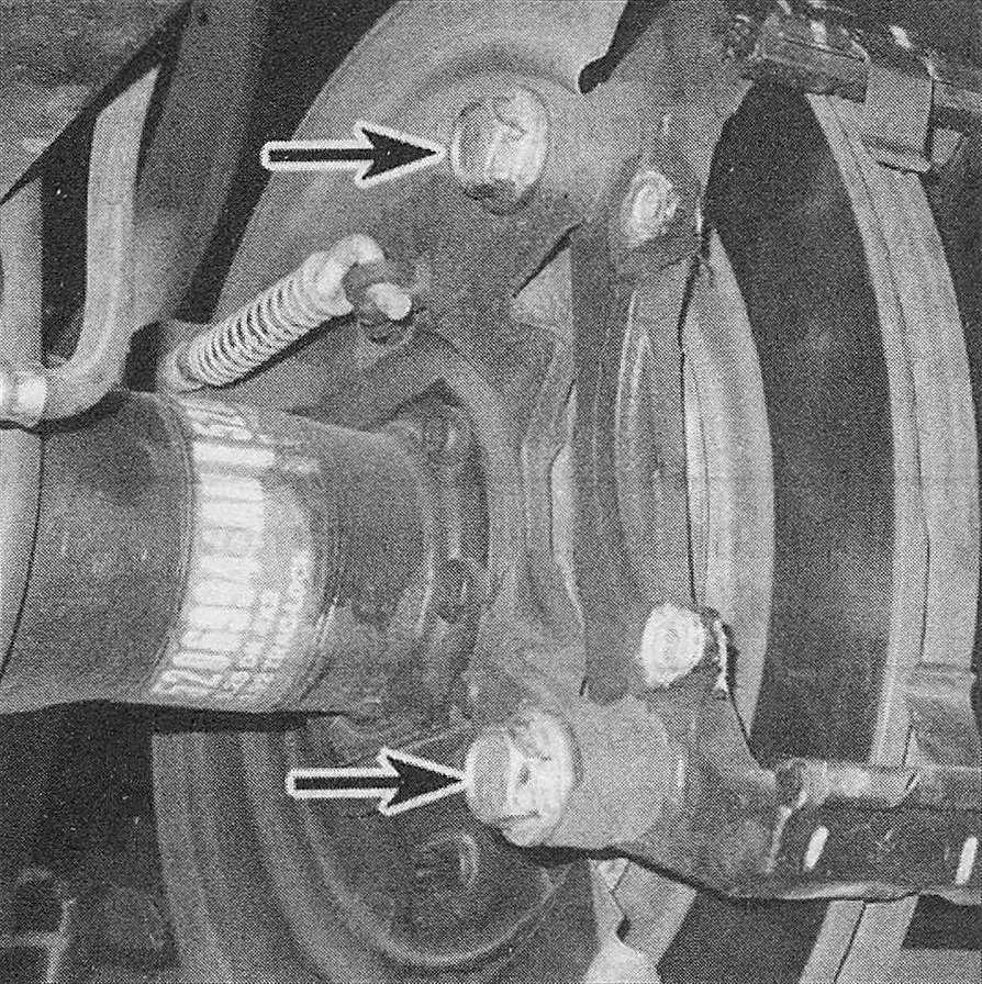 RAM Trucks Brakes The caliper mounting bracket is retained by two bolts (rear shown, front similar)